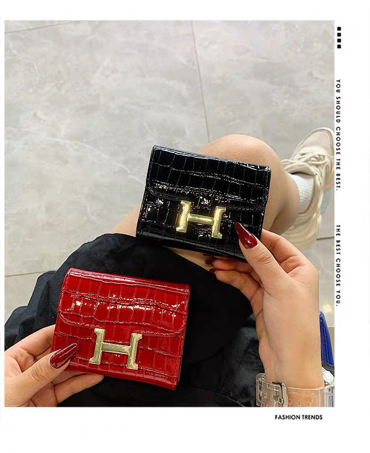 Hermès Constance Compact Wallet In rose gold hardware.